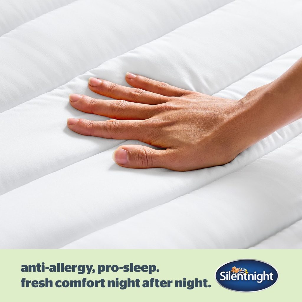 Hand on the quilted surface of the Silentnight Anti-Allergy topper