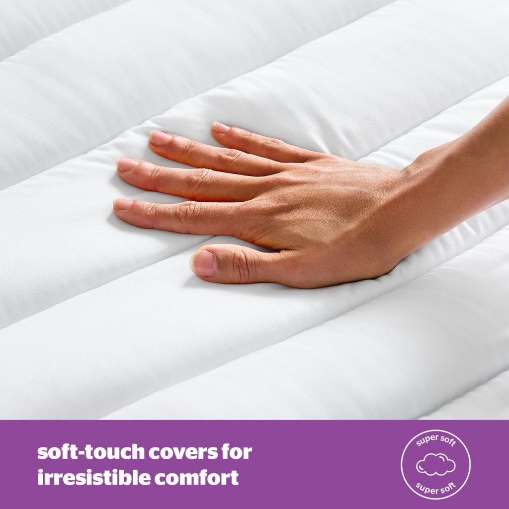 Hand on the soft cover of the Silentnight Deep Sleep topper