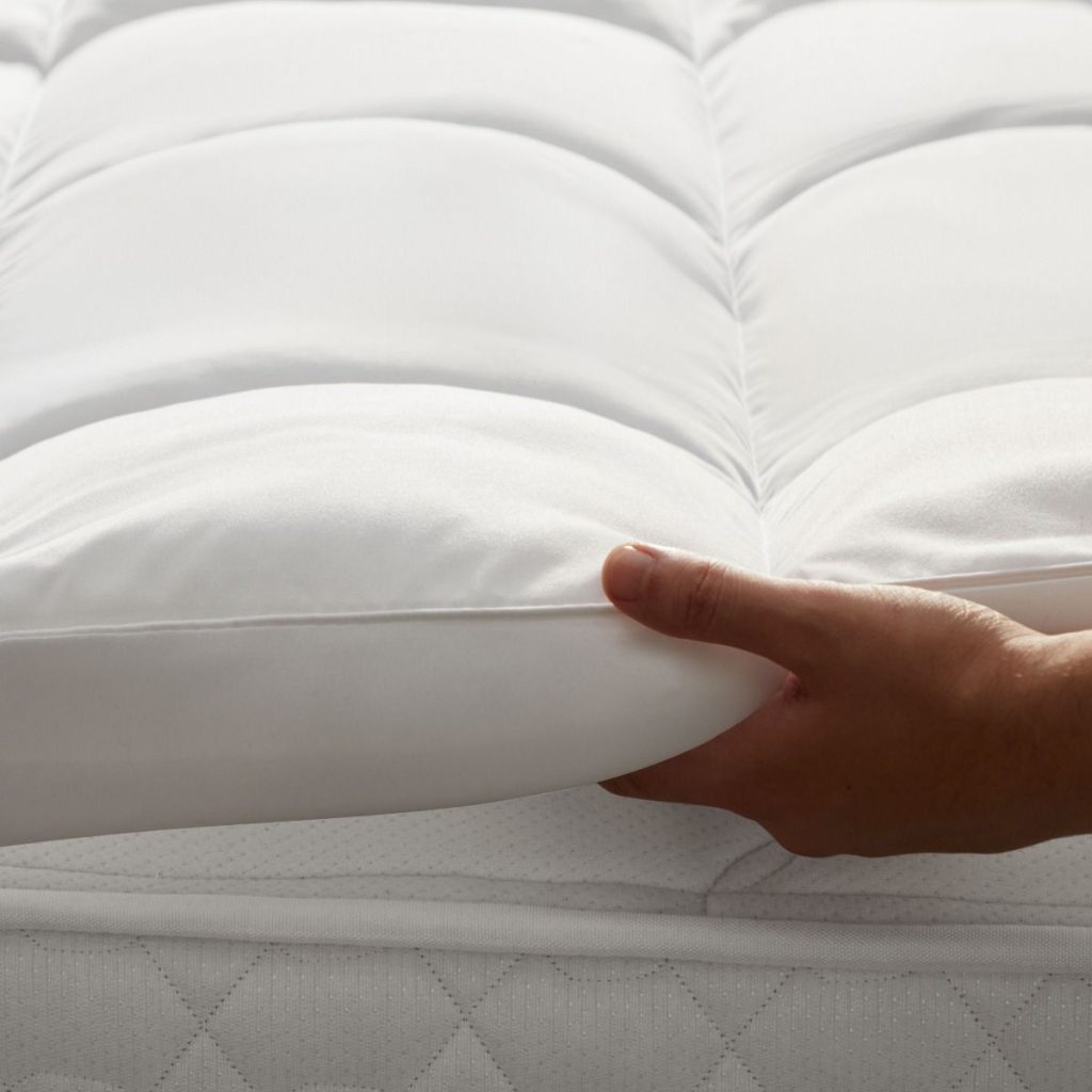Hand pressing the quilted Silentnight Deep Sleep Ultimate 500 topper