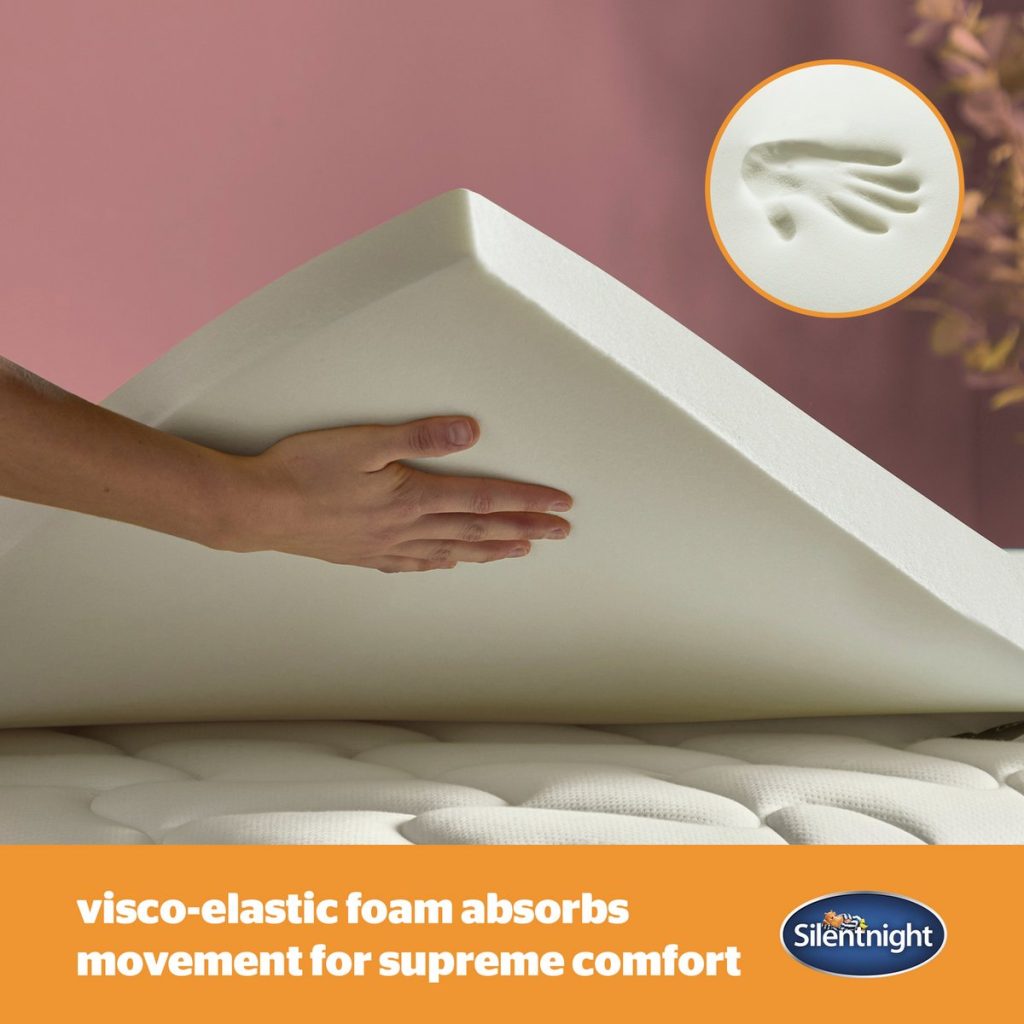 Hand pressing the memory foam of the Silentnight Impress 7cm topper