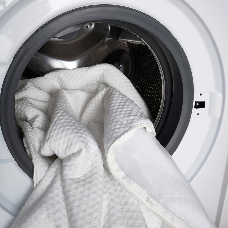 IKEA Åkrehamn removable cover going into a washing machine