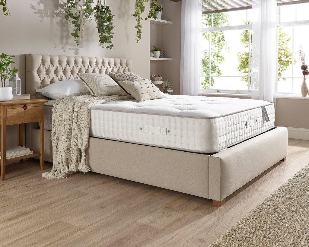 Aspire 7000 mattress on an upholstered bed in a bright bedroom