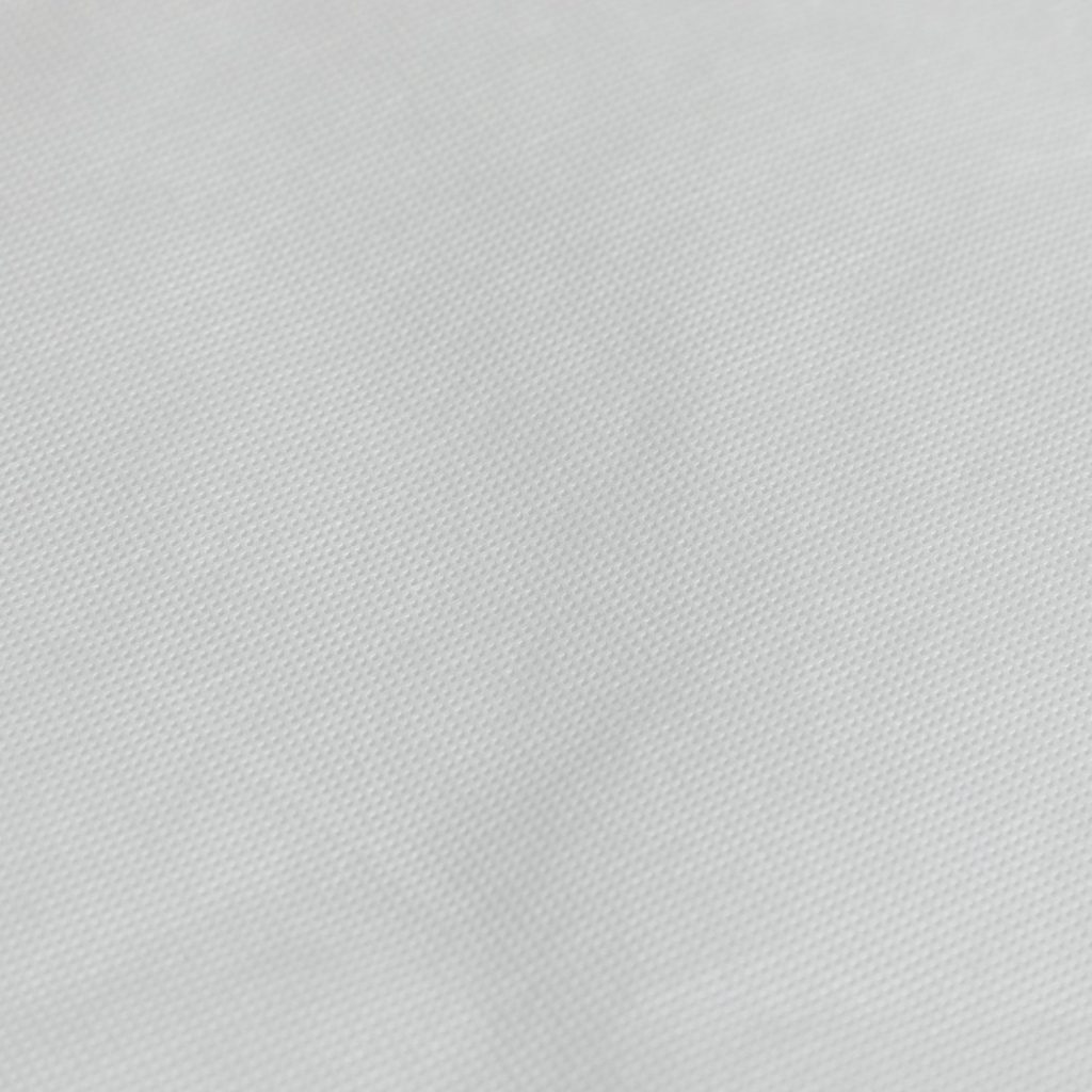Close-up of the white fabric cover of the Cuggl travel cot mattress