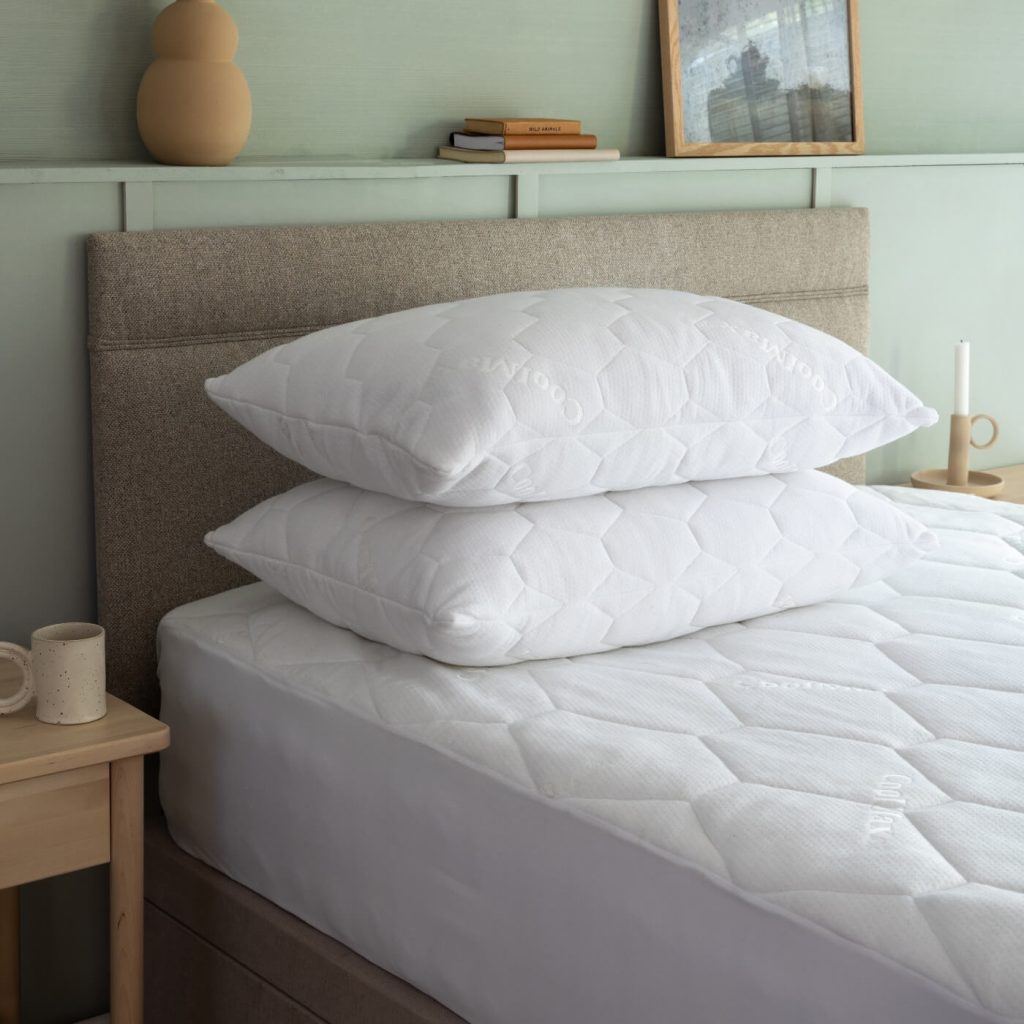 Soak&Sleep Coolmax mattress protector on a bed with two pillows