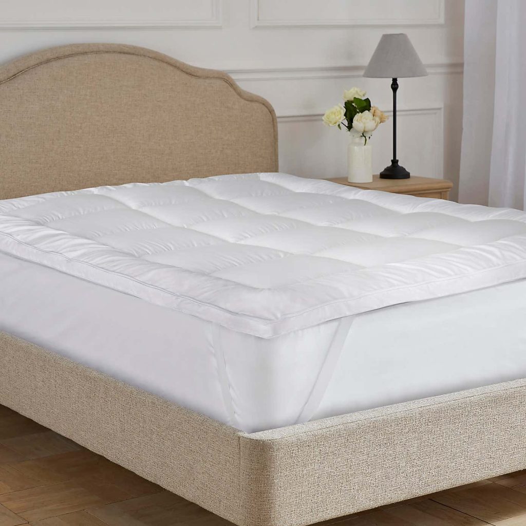 Dorma Dream Dual Layer Mattress Topper on a bed, side view of the gusset