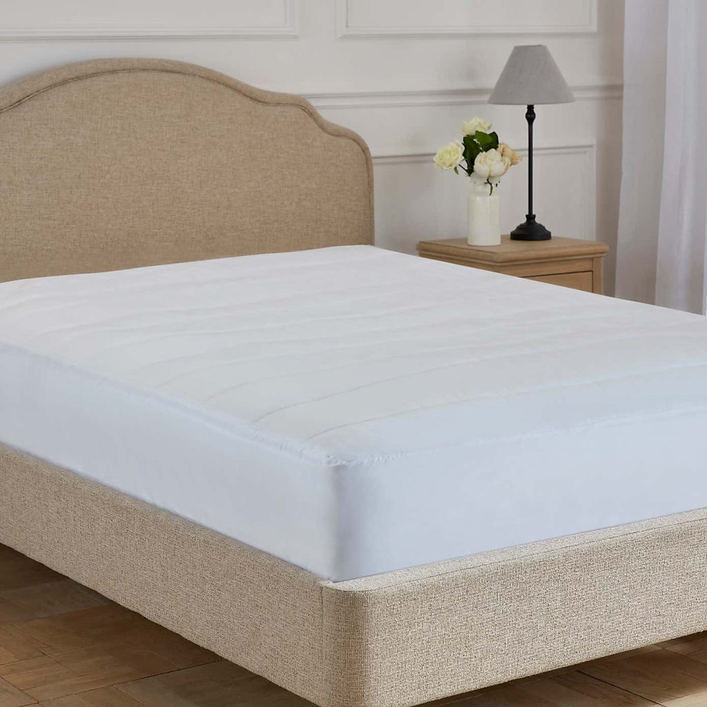 Dorma Luxury Wool Reversible topper cotton side up on a bed