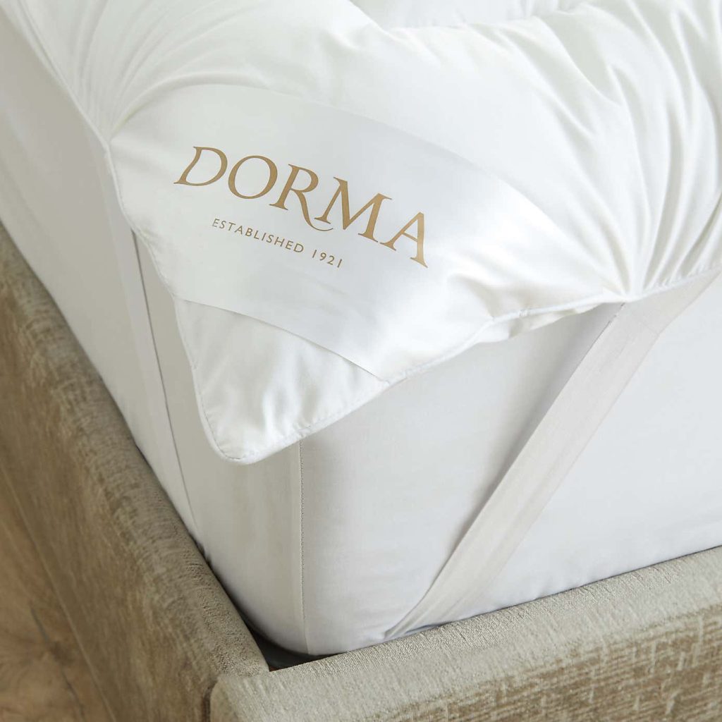 Dorma Sumptuous Soft topper corner with the Dorma label and strap