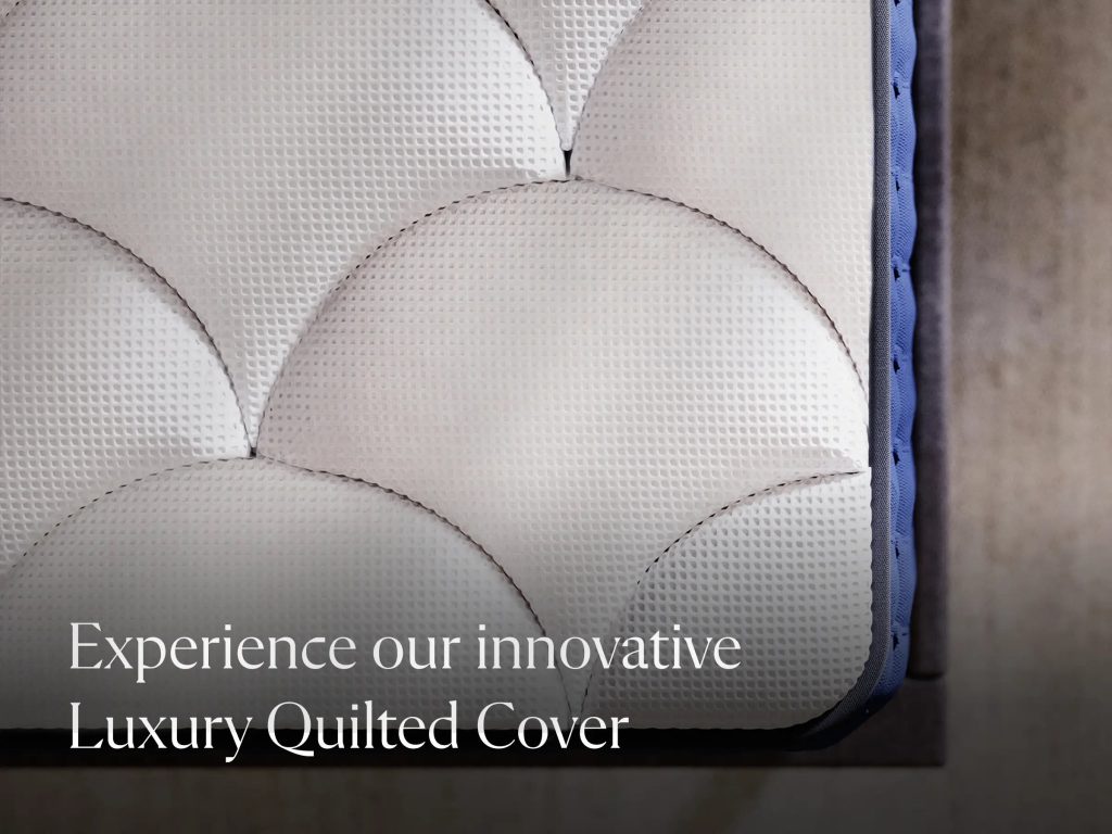 Close-up of the quilted cover and navy side panel of the DreamCloud Hybrid