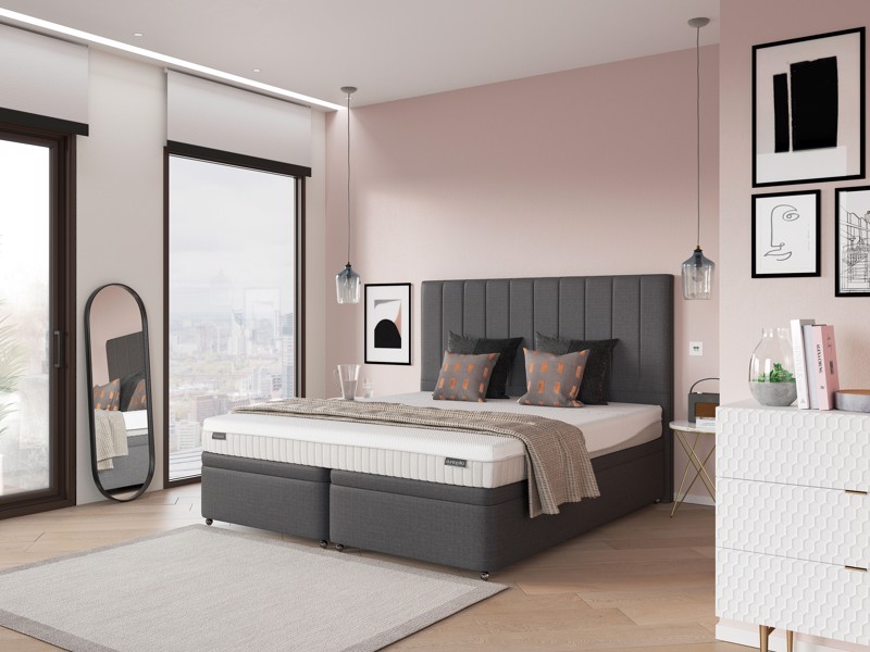 Dunlopillo Firmrest mattress on a grey divan bed in a pink bedroom