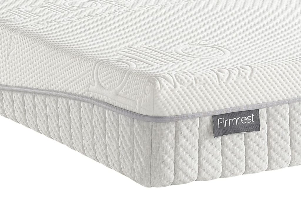 Corner of the Dunlopillo Firmrest showing the knitted side panel and Firmrest label