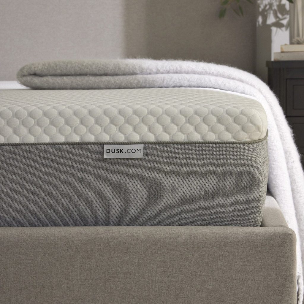 Corner of the DUSK Memory Foam 2000 mattress with knitted top and grey border