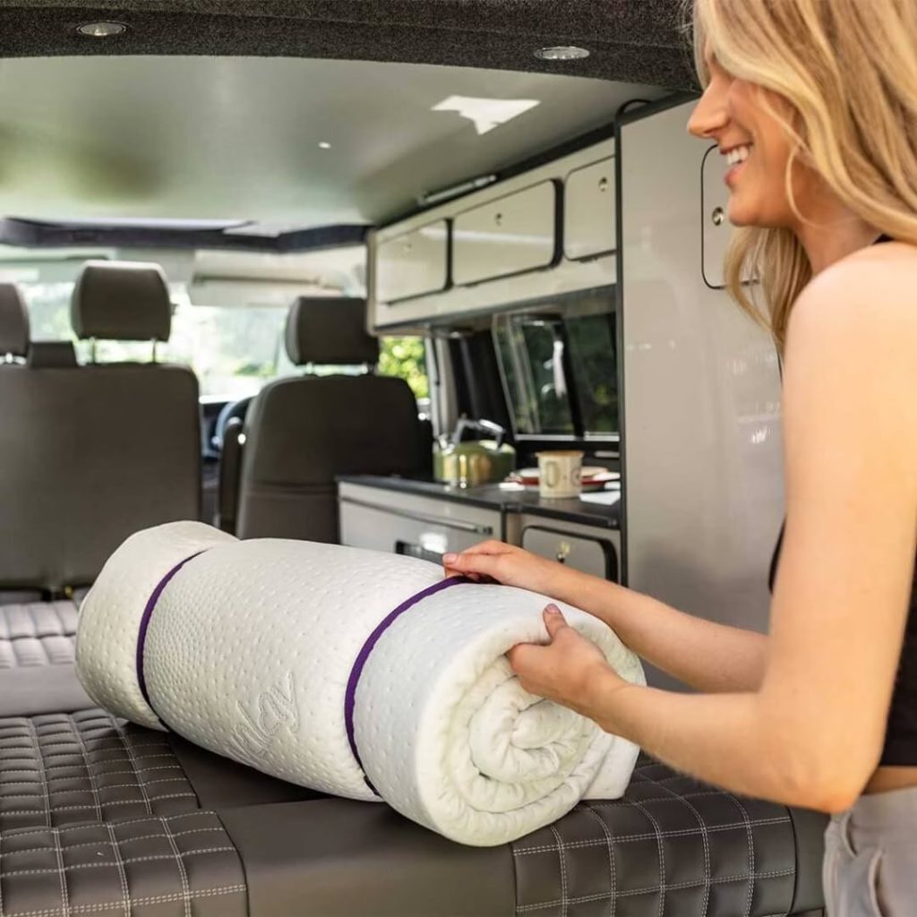 Duvalay Travel Topper rolled in the back of a campervan
