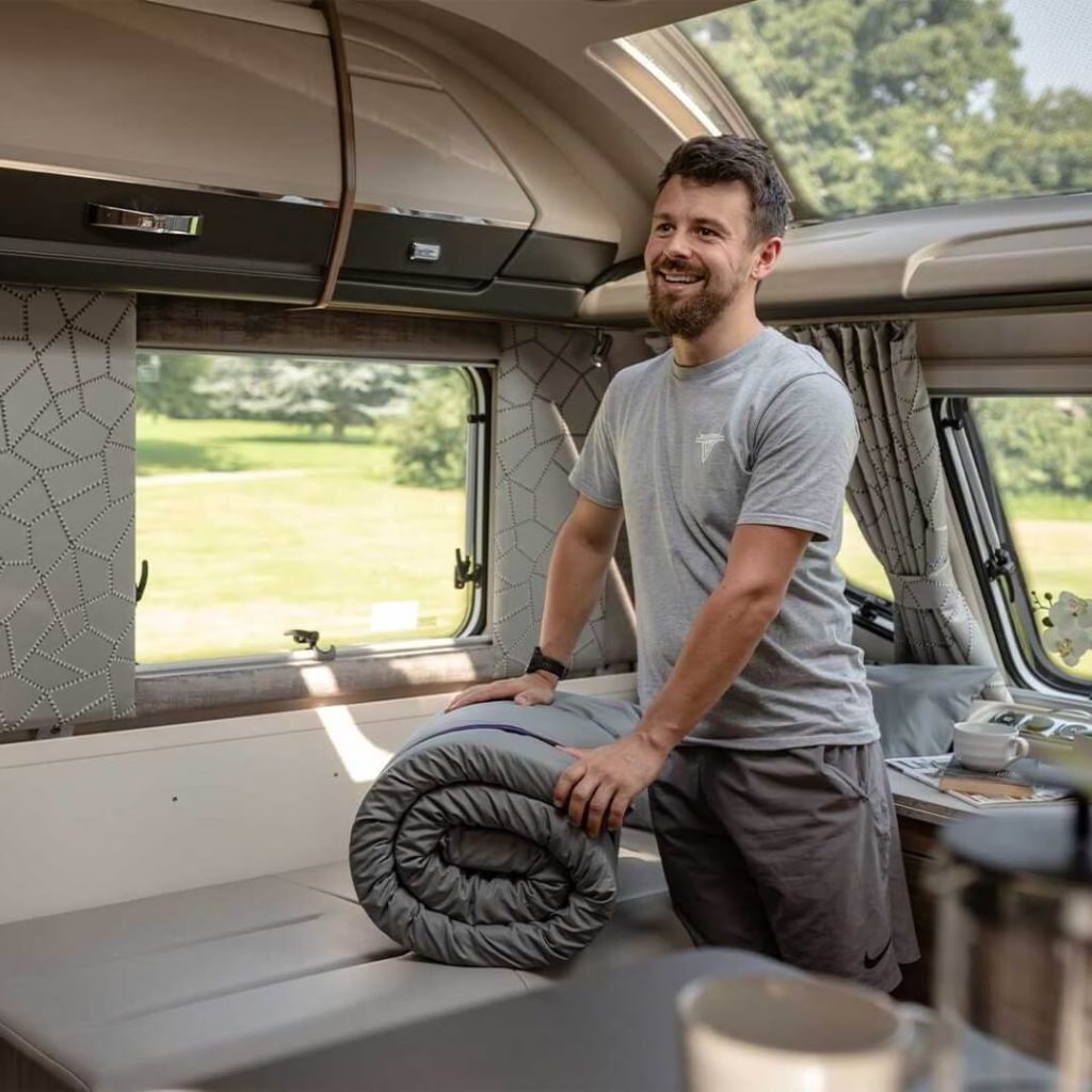 Duvalay Travel Topper with a grey sheet on a caravan bed