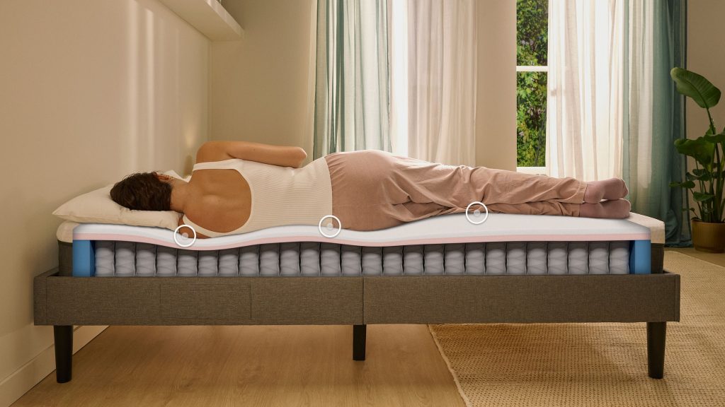 Woman sleeping on her side on an Emma Original Lite mattress in a bedroom