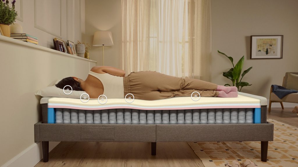 Woman sleeping on her side on an Emma Original mattress with the layers shown
