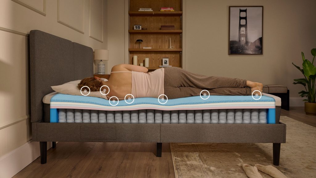 Woman sleeping on her side on an Emma Original Pro mattress with the layers shown