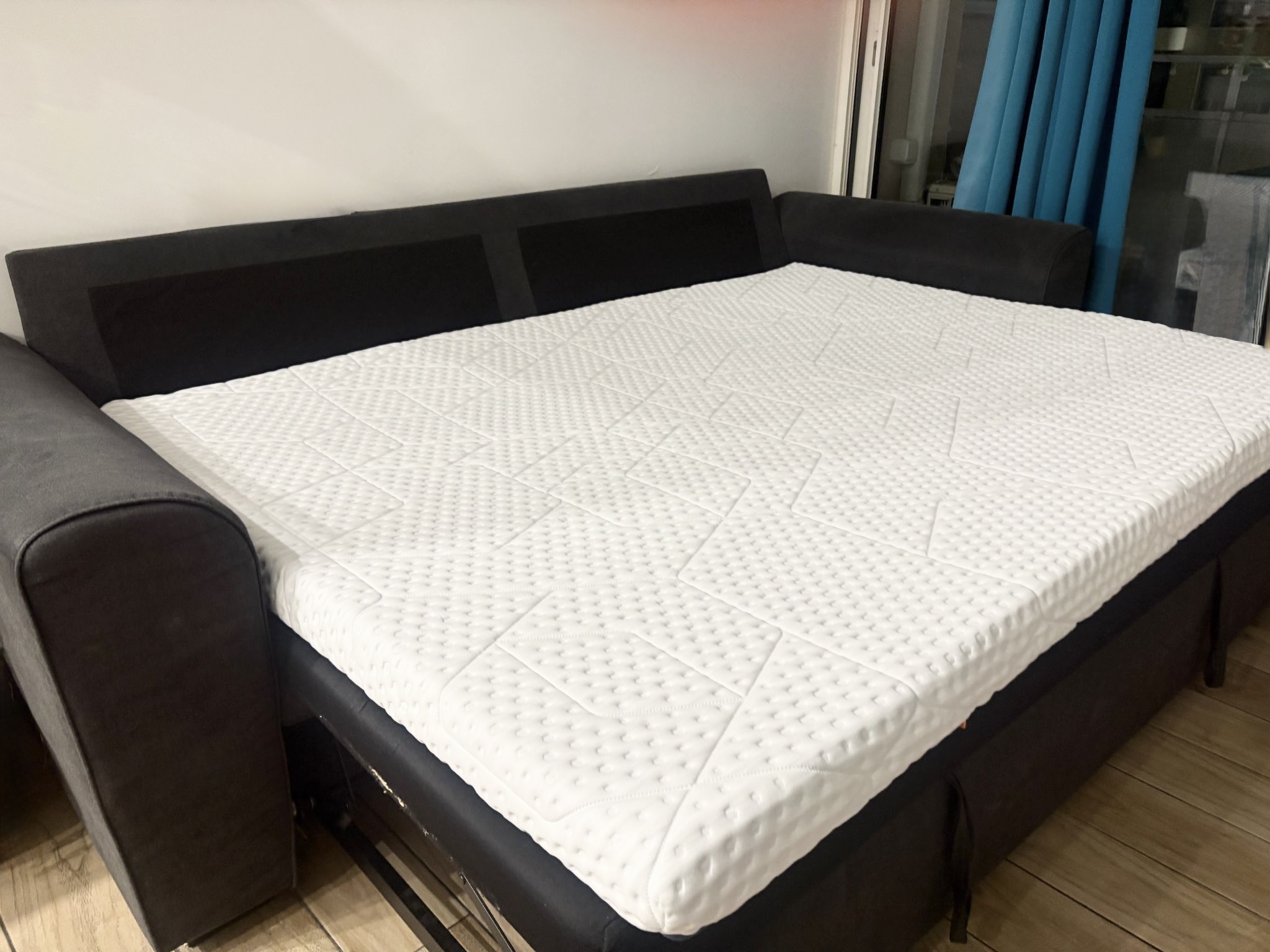 The Emma Original Pro Topper on an opened sofa bed in our test