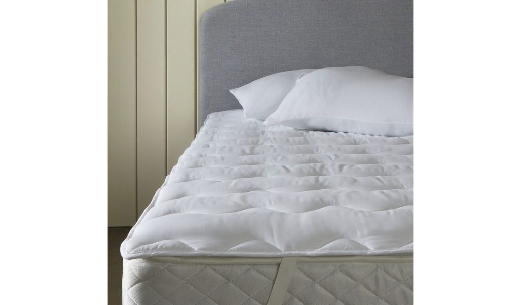 Habitat Supersoft 2cm Mattress Topper on a bed with pillows