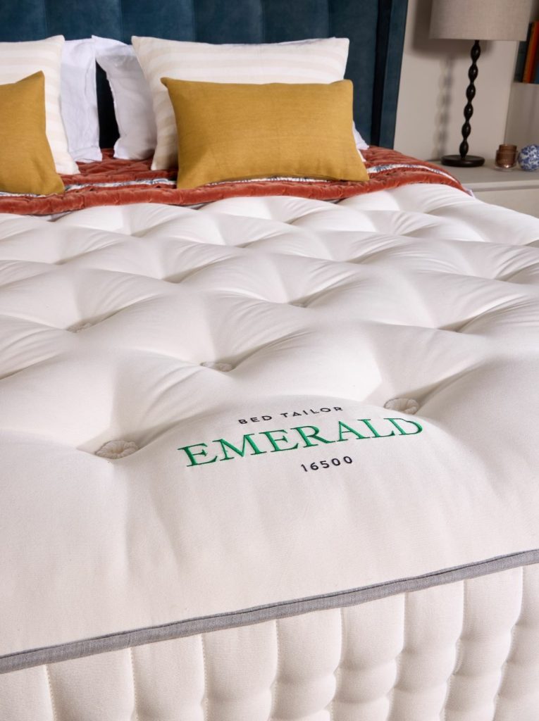 Close-up of the embroidered Emerald 16500 label and hand tufting on the mattress top