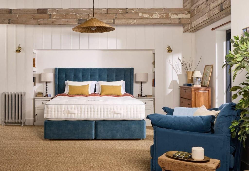 Harrison Spinks Emerald 16500 mattress on a blue divan in a bright country bedroom