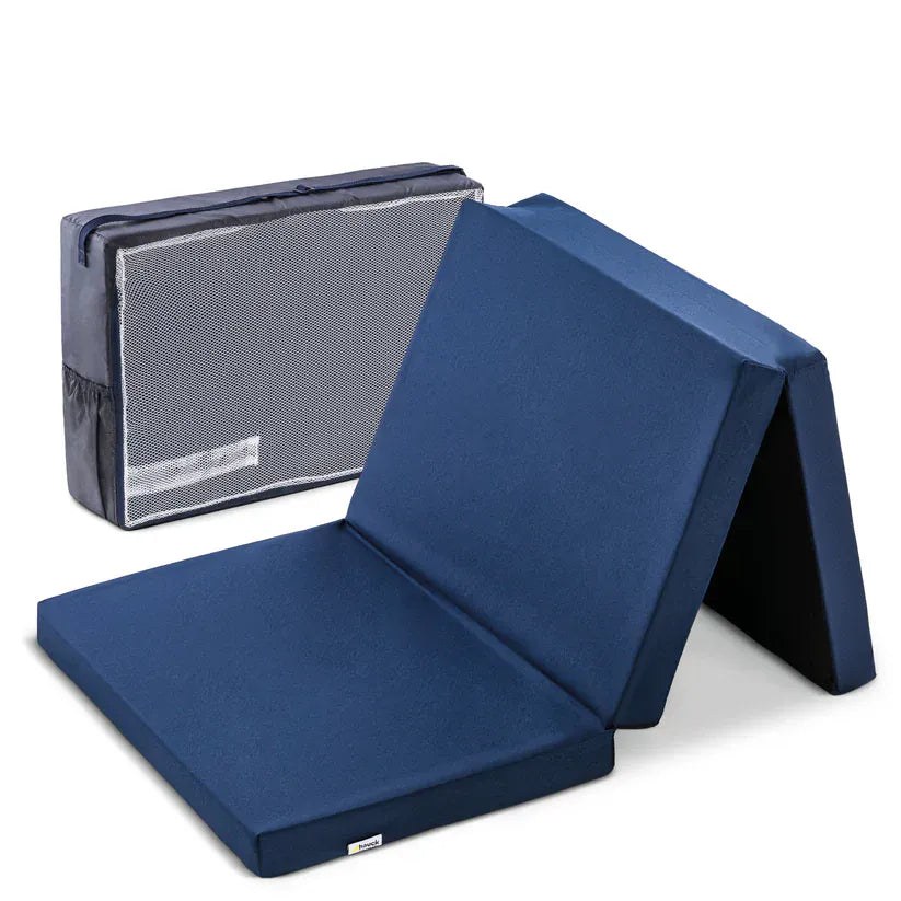 Hauck Sleeper Folding Travel Cot Mattress in navy, part folded next to its carry bag