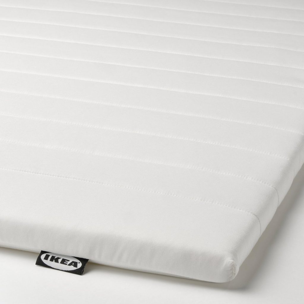 IKEA Näsfjället mattress pad, close-up of the quilted cover and IKEA label