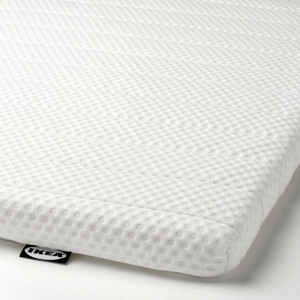 IKEA Nisseholm mattress pad, close-up of the textured cover and IKEA label