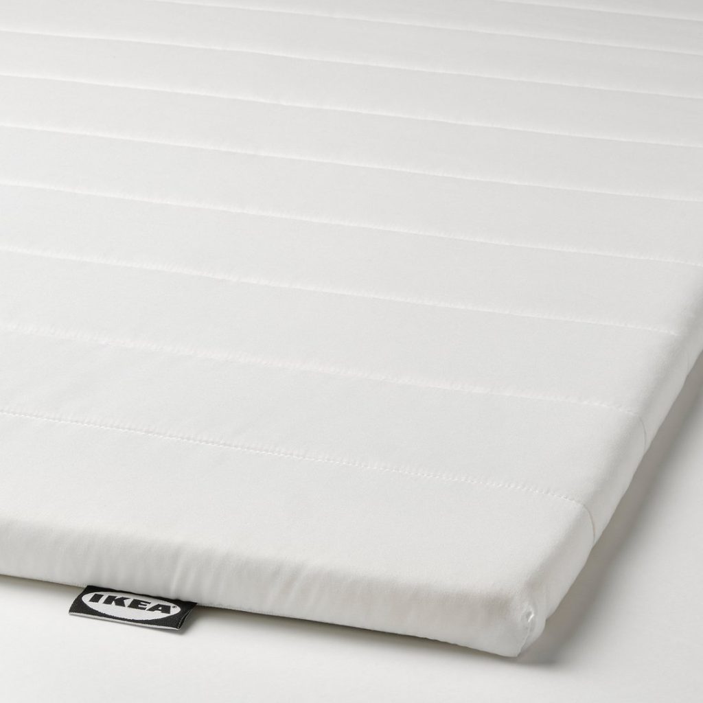 IKEA Nopakte mattress pad, close-up of the quilted cover and IKEA label