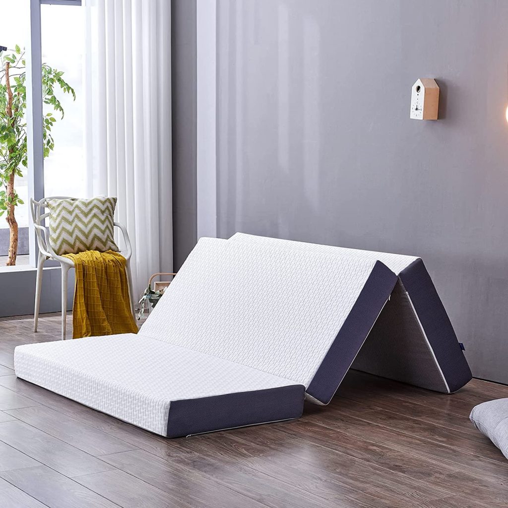 Inofia Tri-Fold mattress partly unfolded on a wooden floor