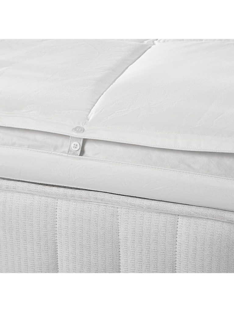 Edge of the John Lewis British Wool Mattress Topper fitted over a mattress