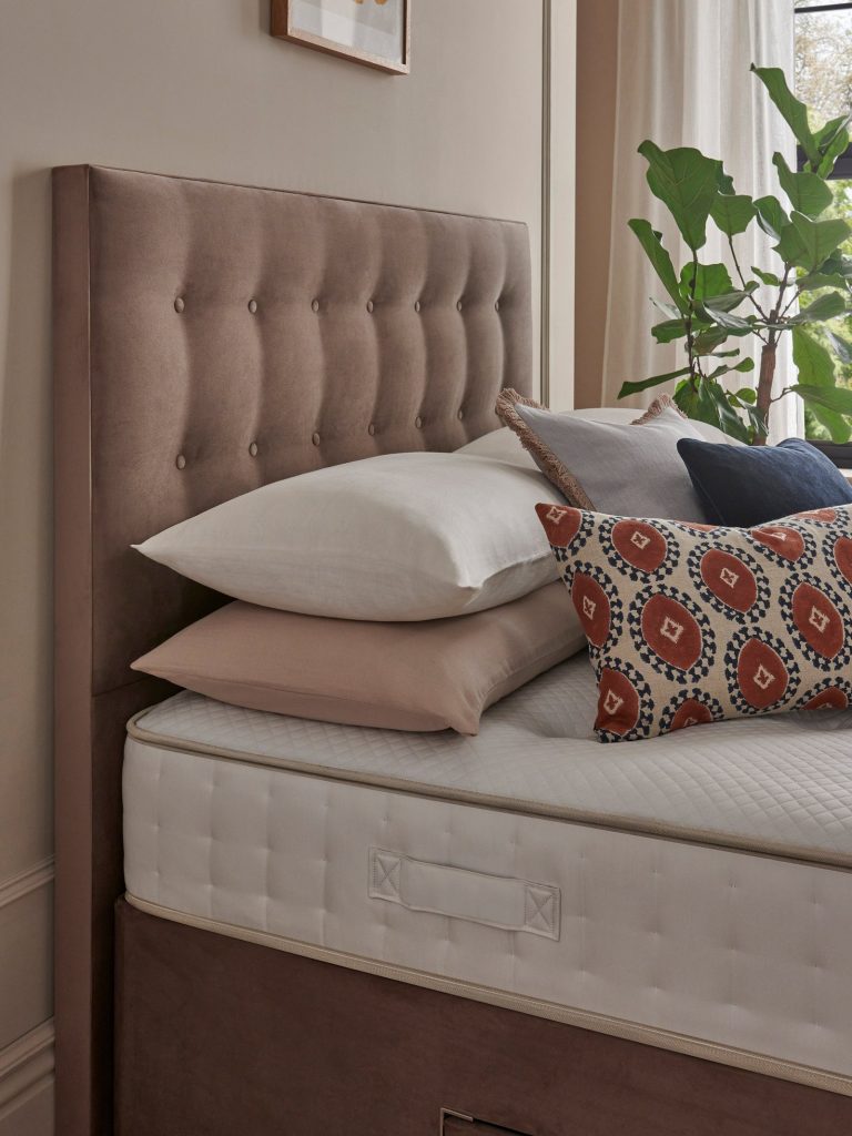 John Lewis Ortho Pocket Collection 1400 Mattress side view with pillows and a buttoned headboard