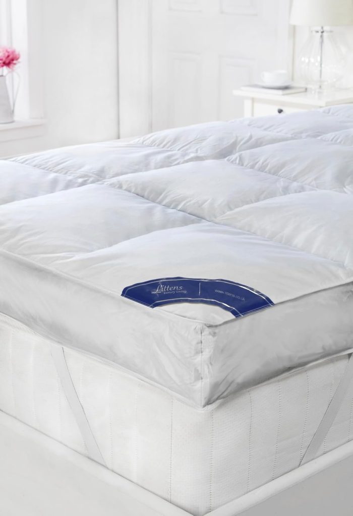 Littens Goose Feather and Down Mattress Topper on a bed with the Littens label