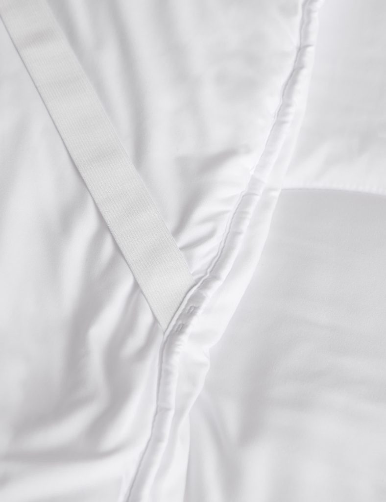 Bound edge and corner strap of the M&S Everyday Mattress Enhancer