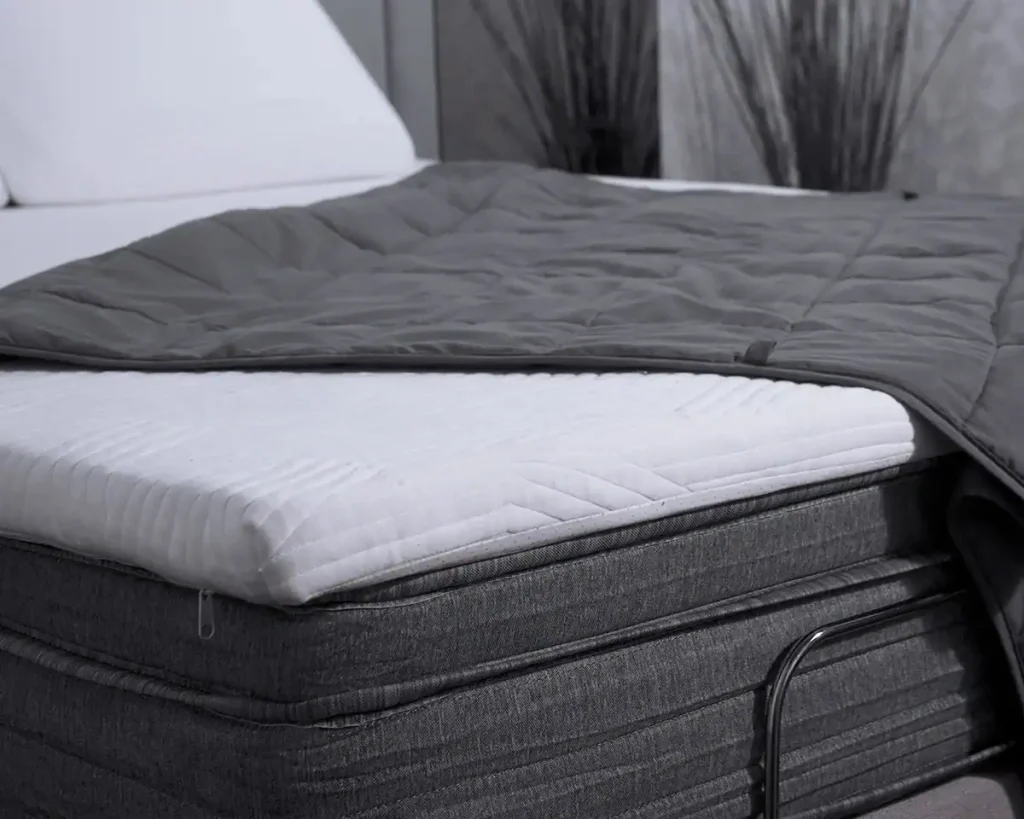 Origin Contour Mattress Topper on a mattress with grey bedding