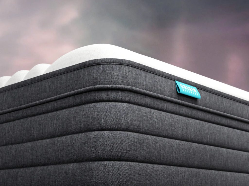 Close-up of the Origin Hybrid mattress corner with its quilted grey side panel