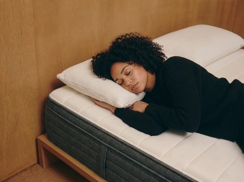 Woman sleeping on her side on the Origin Hybrid mattress