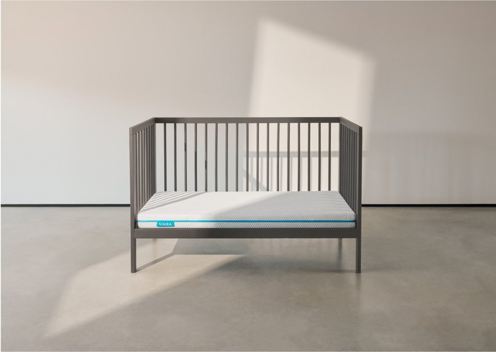 Simba Hybrid Cot Bed Mattress in a grey cot in a bright room