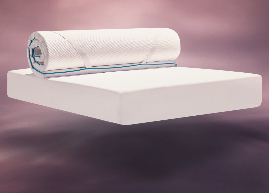 Simba Hybrid Essential Mattress Topper being rolled out onto a mattress