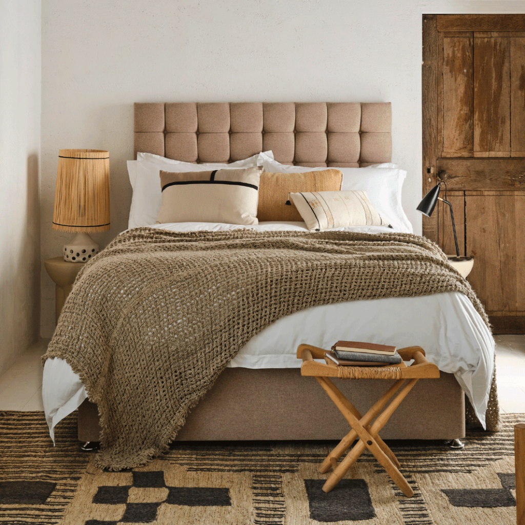 Sleepeezee Wool Luxe 2800 mattress made up on a divan with a buttoned headboard