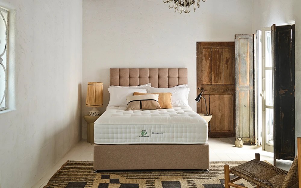Sleepeezee Wool Luxe 2800 mattress on a divan with a buttoned headboard