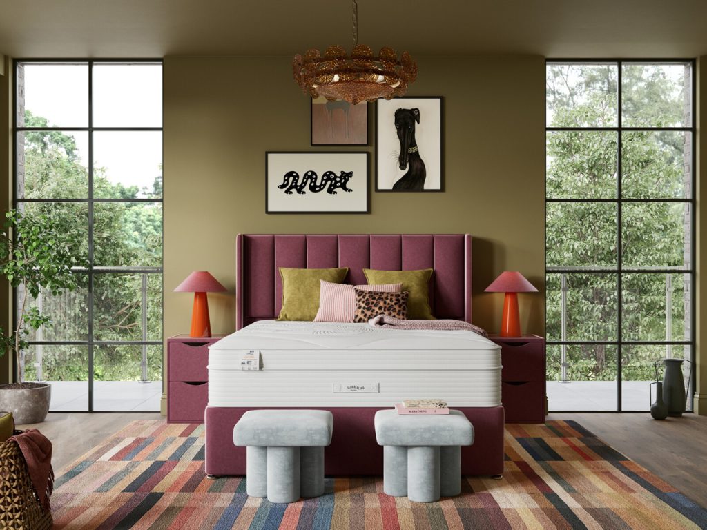 Slumberland Air 9.0 Memory mattress on a burgundy divan in a bedroom with tall windows