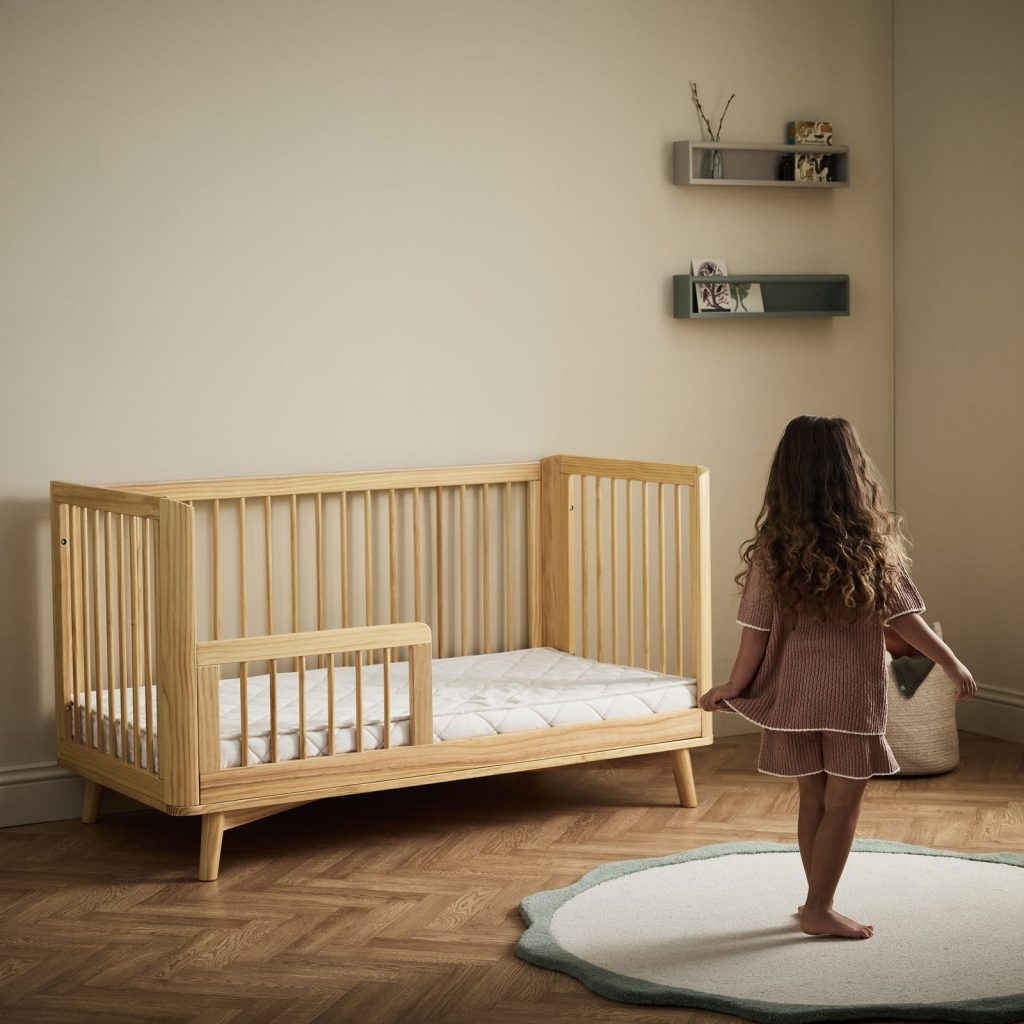 The Little Green Sheep Twist Natural Cot Bed Mattress in a cot bed converted for a toddler