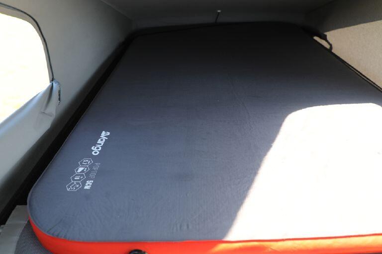 Vango PopTop 5cm laid out on the bed of a campervan