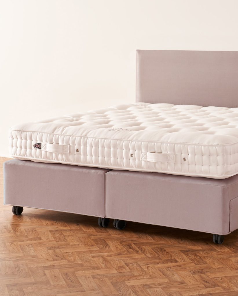 Vispring Baronet Superb mattress on a lilac upholstered divan on castors