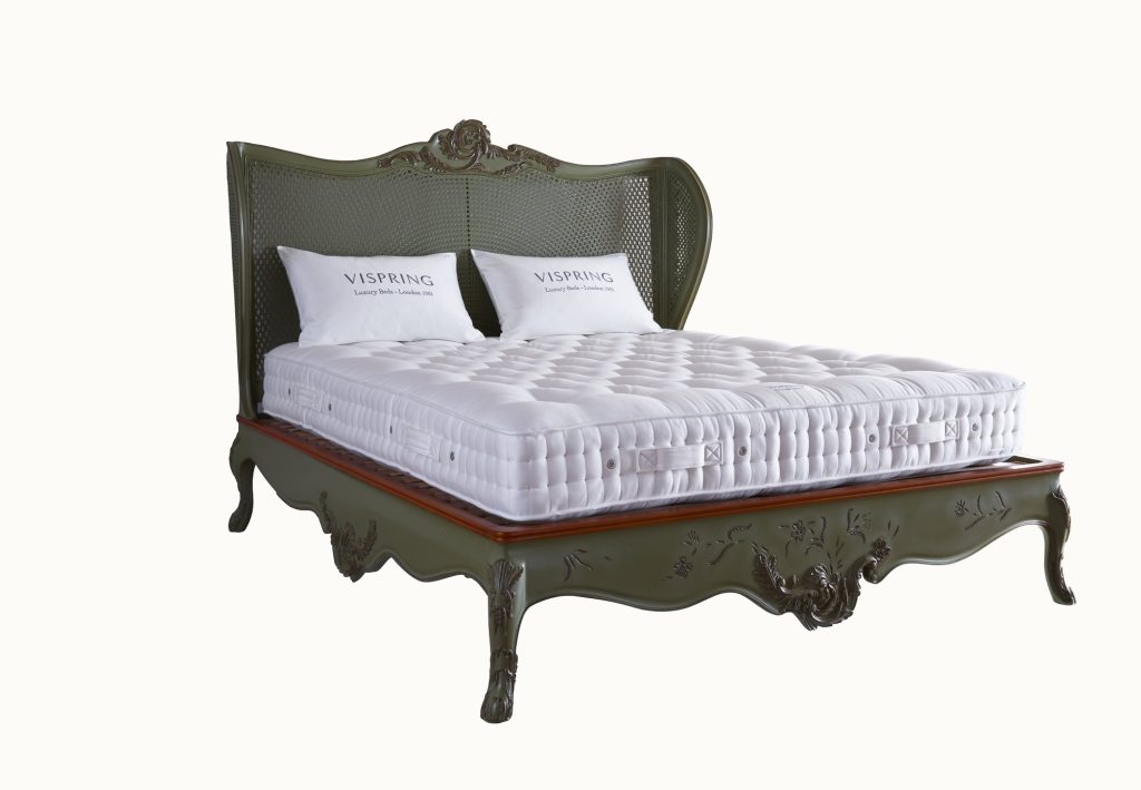 Vispring Bedstead Traditional mattress on a carved green wooden bedstead