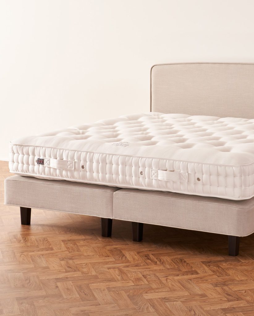Vispring Elite mattress on a beige upholstered divan with headboard