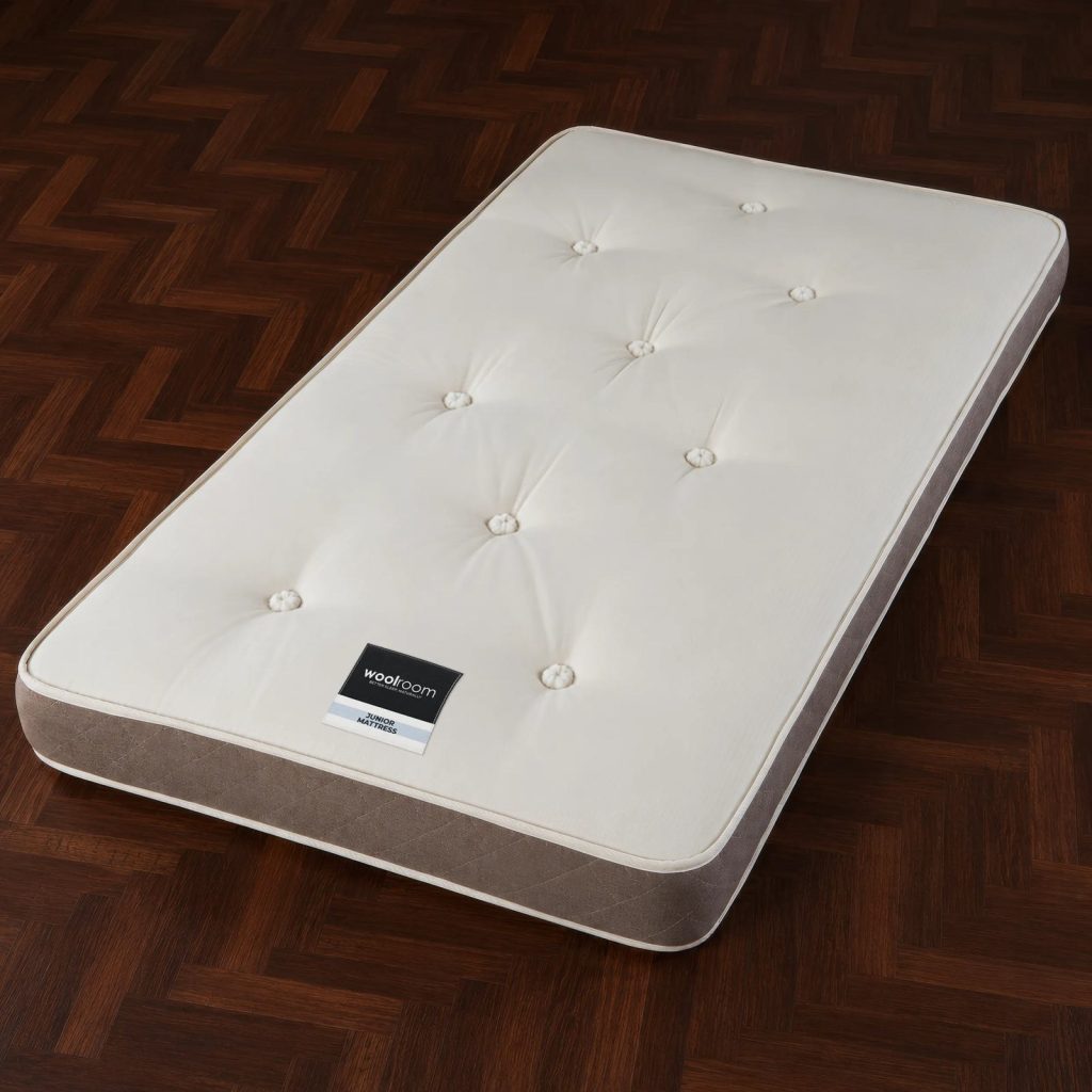 Woolroom Junior single mattress on a dark wooden floor