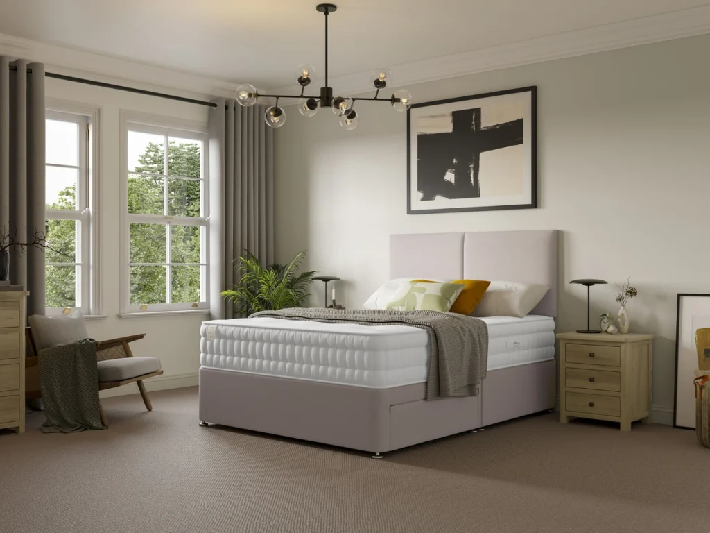 Slumberland Naturals Plant-Based Luxe on a beige divan in a bright bedroom
