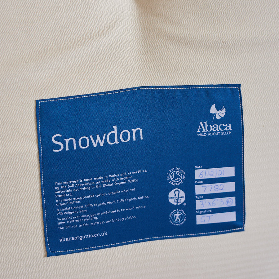 Abaca Snowdon mattress label stating Soil Association certification to the Global Organic Textile Standard