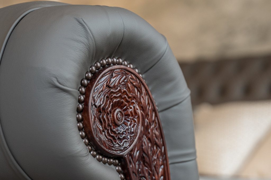 And So To Bed Bonaparte Deep Buttoned Bed close-up of the carved scroll and stud trim